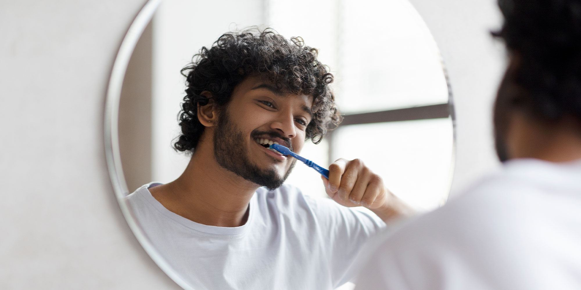man brushing teeth