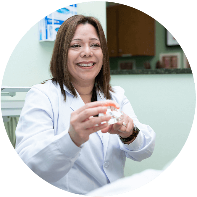 Doctor holding a model of full arch implants