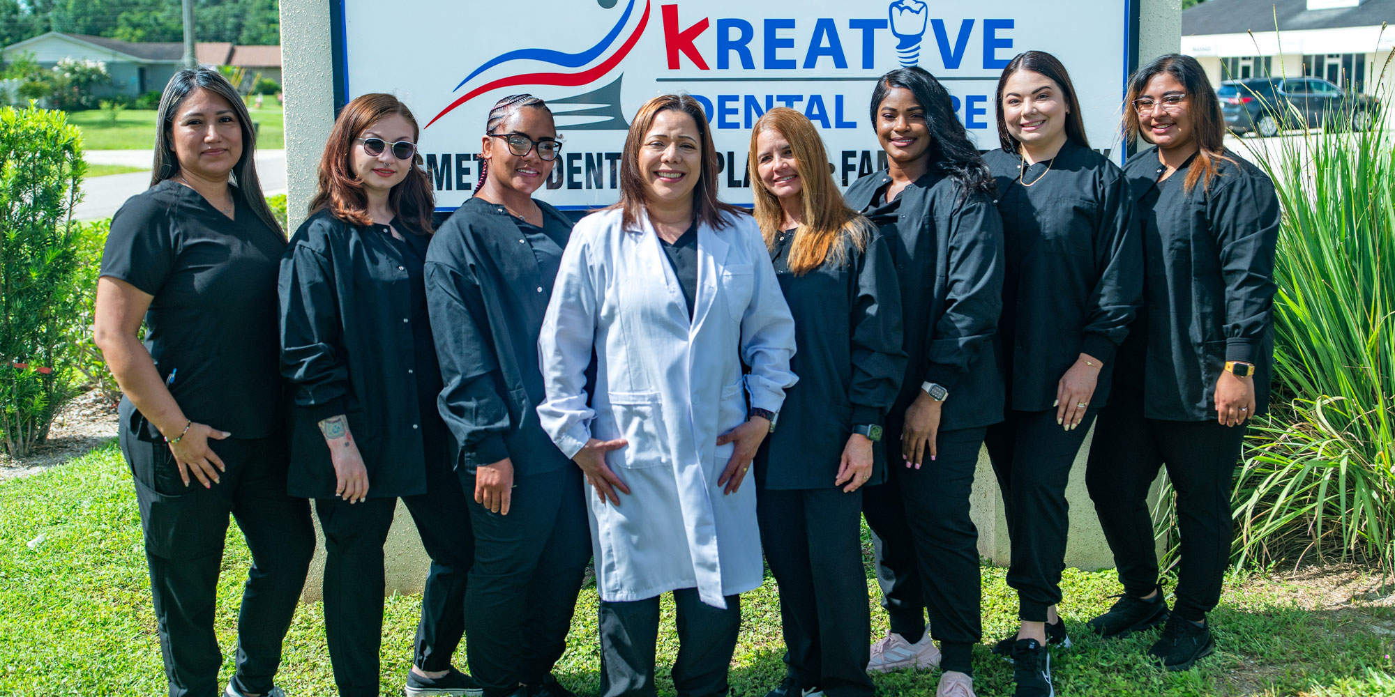 Team members and doctor smiling together